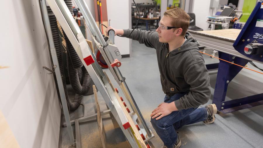 Student working with machinery
