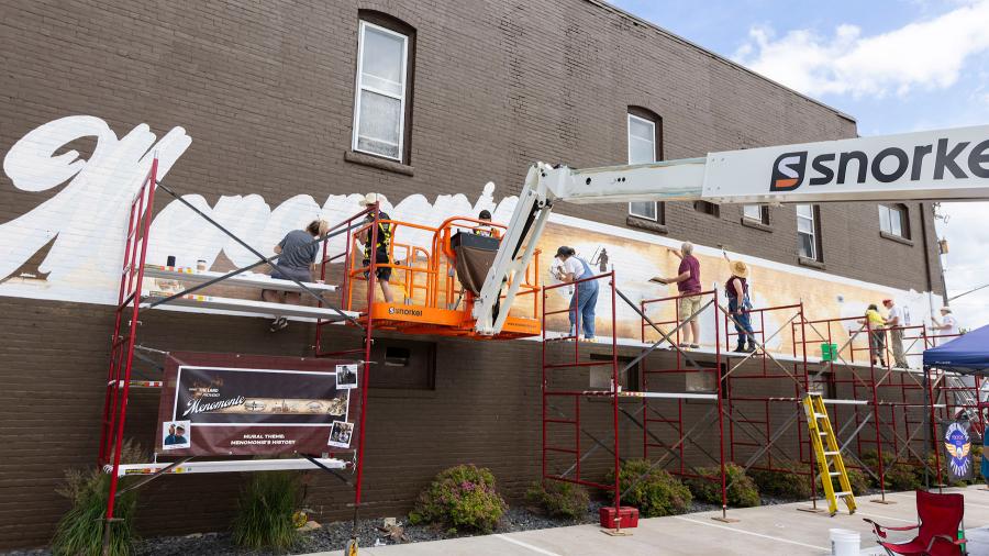 Painters work on mural
