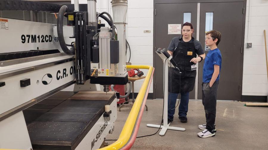 STEAM Construction camper and instructor using the CNC machine