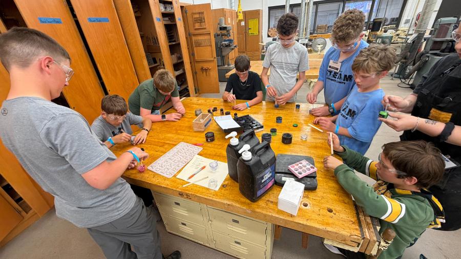 STEAM Construction campers and instructors pouring resin keychains