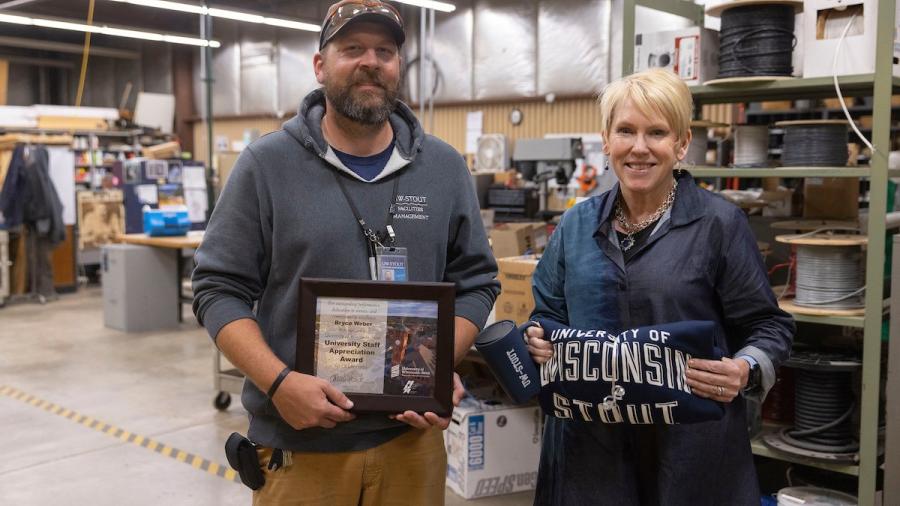 Two people with award