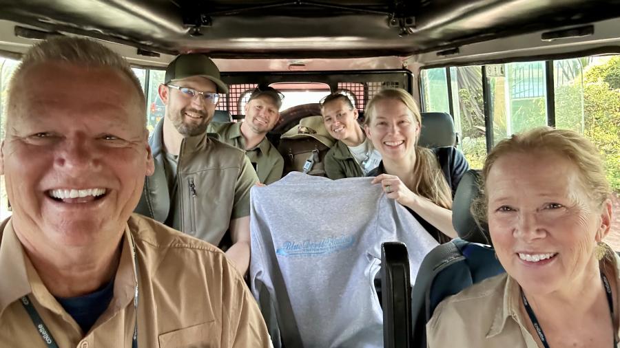 Group of alumni in safari vehicle 