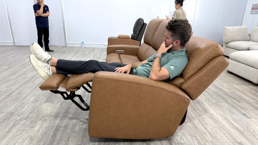 Man sitting on reclining sofa
