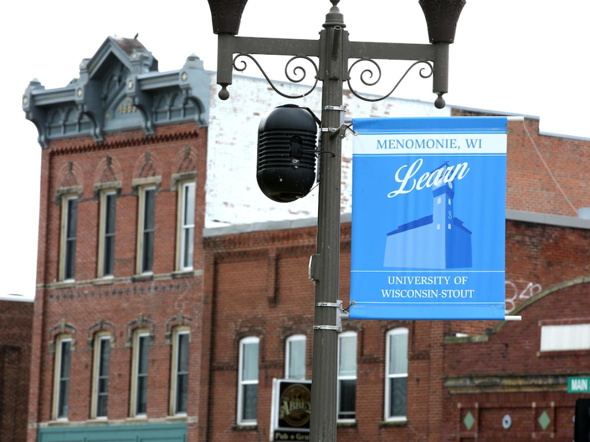 A lamp post banner featuring UW-Stout is seen on Crescent Street as a yearlong project to beautify the Menomonie community is coming to fruition. 