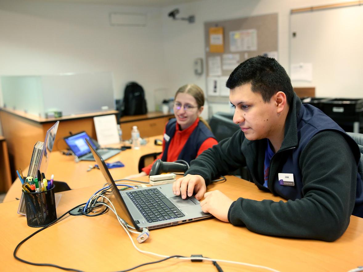 Technology Help Desk student workers Jose Palacios and Allegra Rossum assists people with their computer issues.
