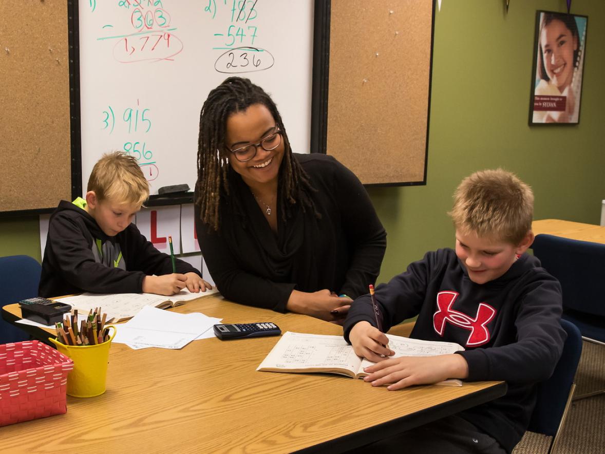 Courtney Jones Holm, an Education Graduate student at UW-Stout, teaches math to brothers Noah and Gabriel.