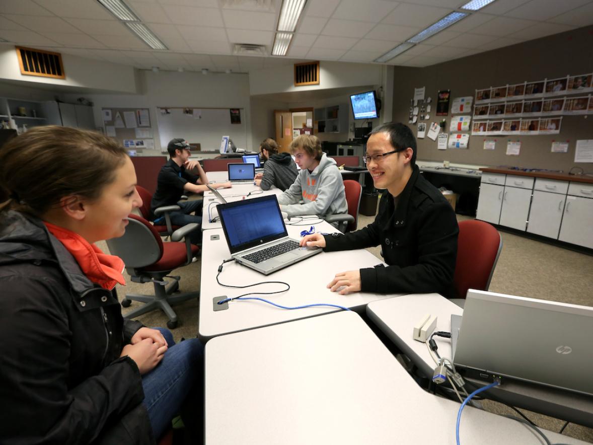 Staff helping a student at the Technology Help Desk in Millennium Hall.