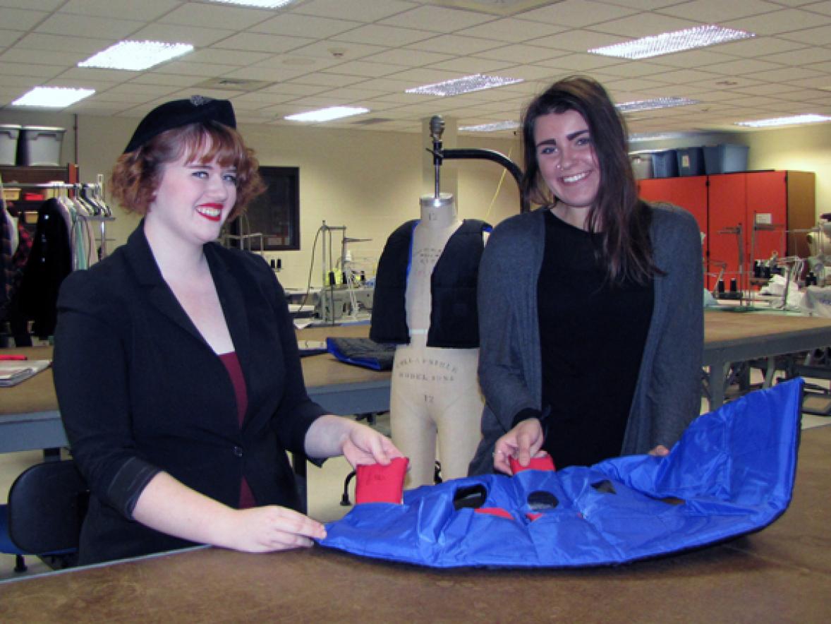 UW-Stout apparel design and development students Kalli Smith, left, and Megan Vande Walle display weighted vests they helped make for a Minnesota school district. The special vests, also seen in the background on the mannequin, help young students who have anxiety.