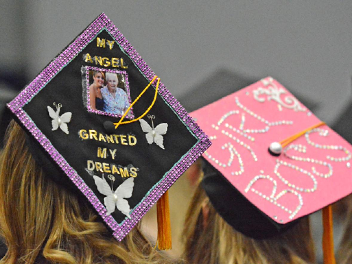 The mortarboard of UW-Stout graduate Kelsey Srdar’s includes a photo herself with her grandmother, Mickey, who died July 4. At right is the cap of "Girl Boss" Samantha Sova, who will be an assistant manager at Kohl's.