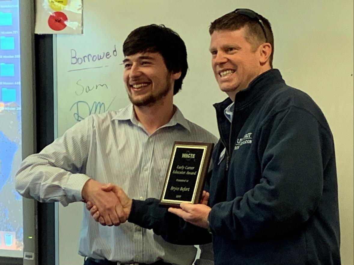 Bryce Befort receives his WACTE award from Professor Kevin Mason.