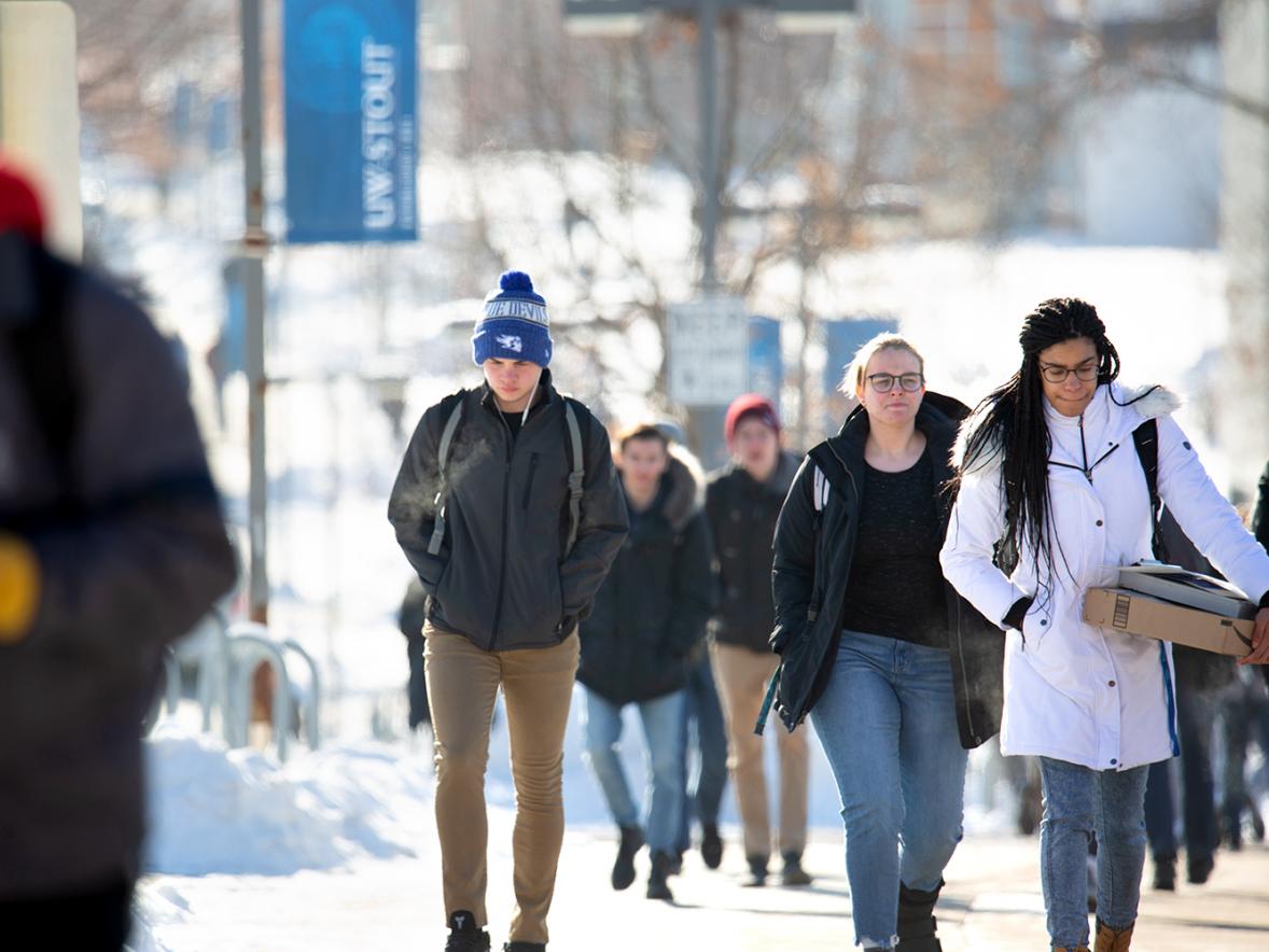 UW-Stout students walk across campus. With finals approaching and the holidays just around the corner, students might be feeling stress. / UW-Stout photo by Chris Cooper