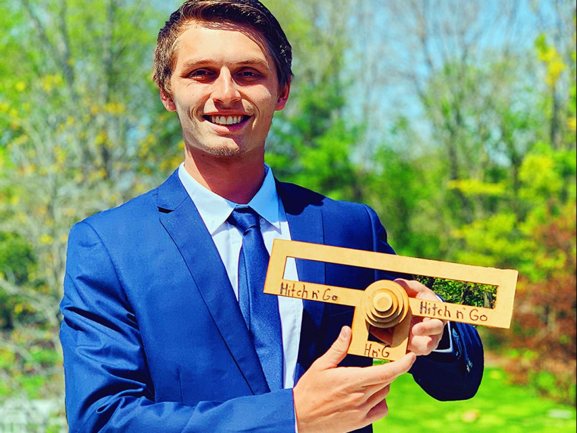 UW-Stout graduate Weston Knutson with a prototype of the Hitch N’ Go.