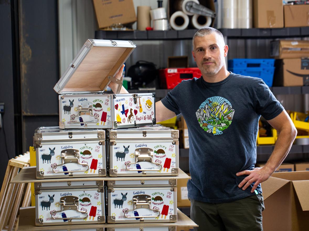 Mark Sieglaff, C&N vice president, inspects an order of custom minitrunks for Heart O’ the Hills Camp in Hunt, Texas.