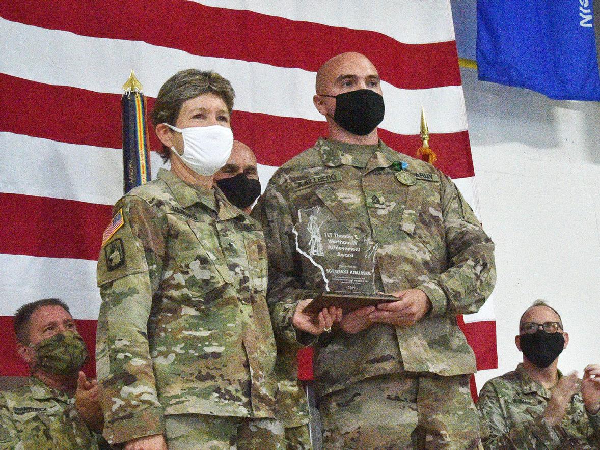 Grant Kjellberg, UW-Stout criminal justice and rehabilitation major, receives the Wisconsin National Guard Wortham Award recently at Volk Field from Brig. Gen. Joane Mathews, Wisconsin’s deputy adjutant general for the Army.