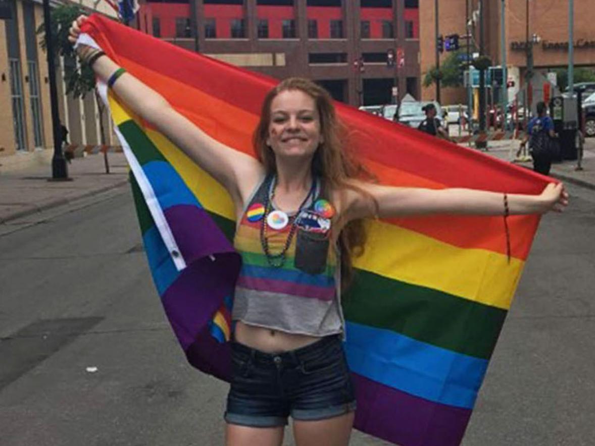 Kathryn Reeves, double major in art education and studio art, with a Gay Pride flag.