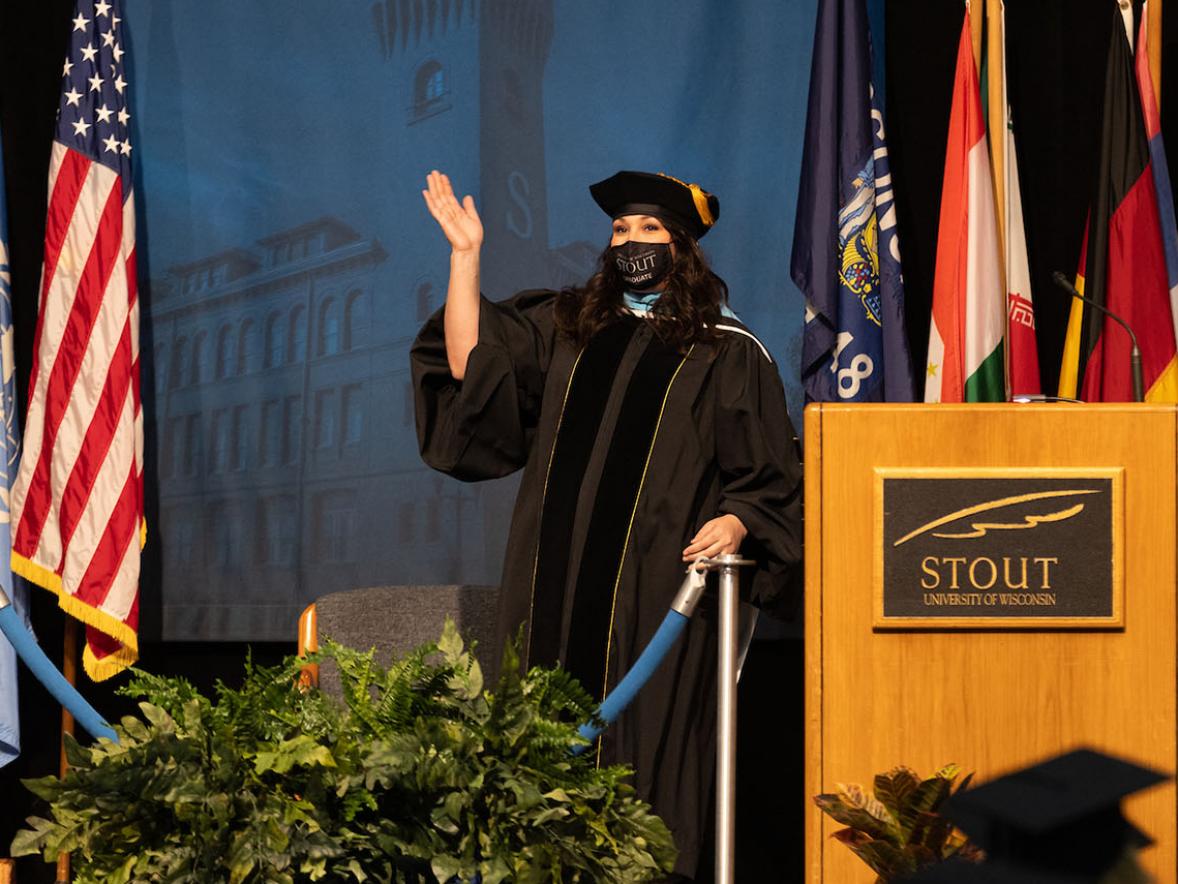 Rachel Krueger crosses the stage to receive her doctorate at the May 2021 commencement.