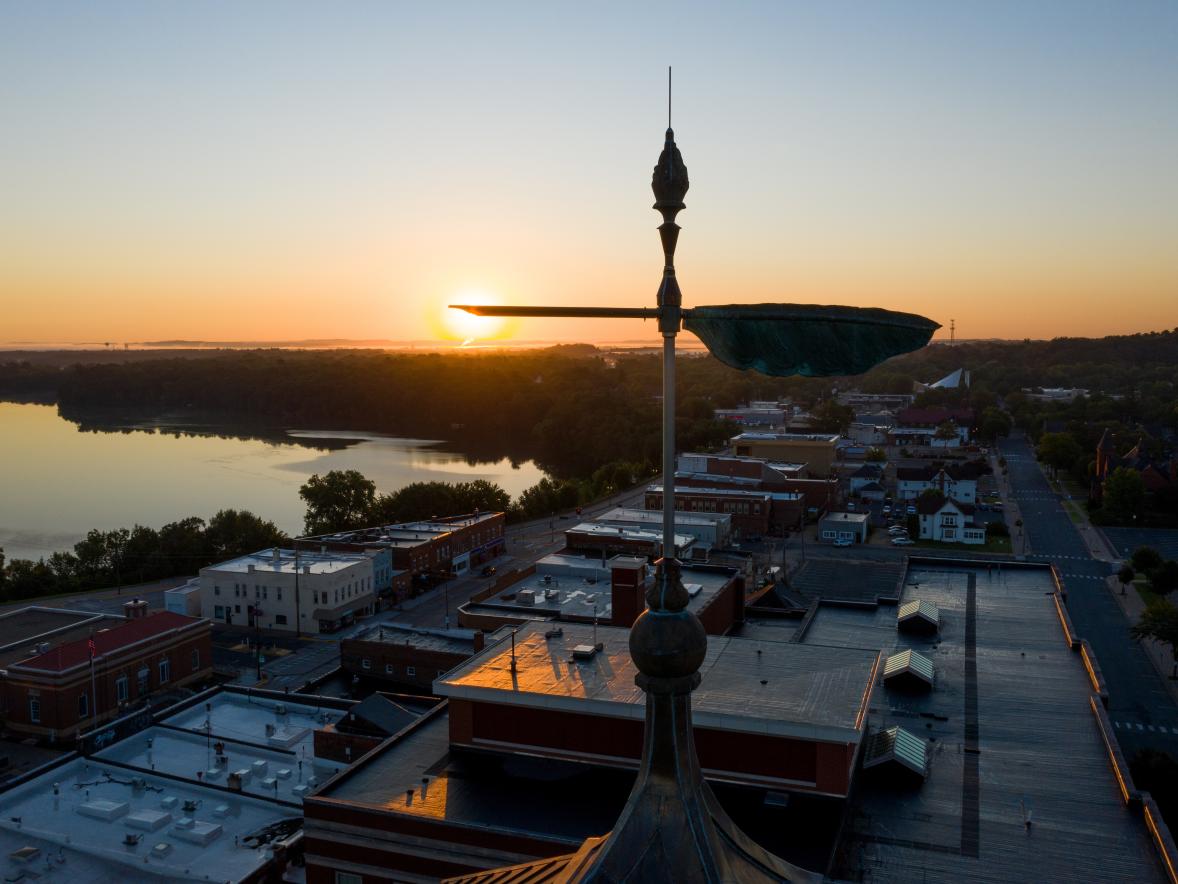 The sun rises over UW-Stout’s Bowman Hall and the quill atop the Clock Tower.