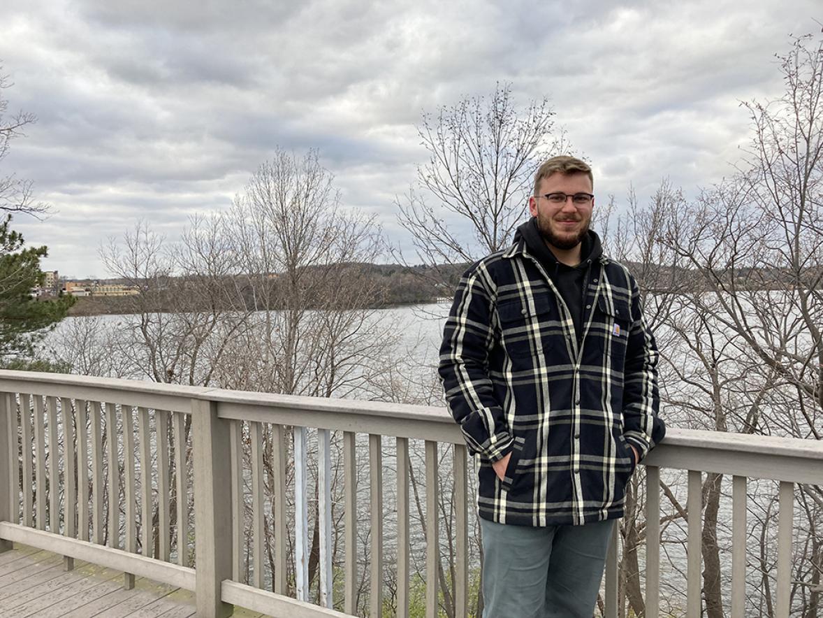 UW-Stout student Rex Meikle stands near the Lakebank Nature Trail at Cedarama Park. He is studying the trail for his minor in sustainability capstone project.