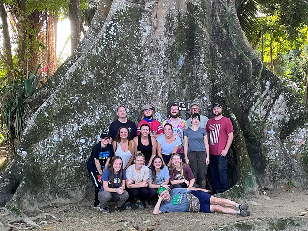 UW-Stout students in the Natural History of the Neotropics course, along with professors Mike Bessert, front on ground, and Steve Nold, second from right in back, stop in front of a giant strangler fig tree while in Belize in January.