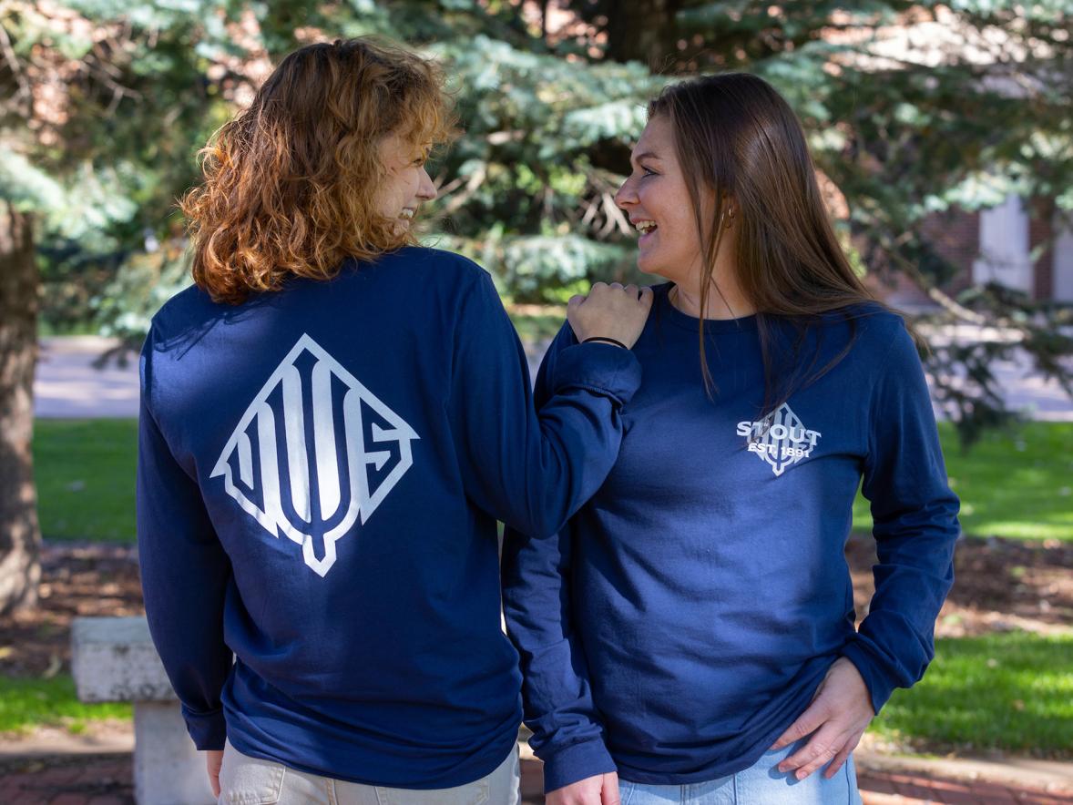 Willa Rodencal, left, and Megan Copeland, two of 13 UW-Stout Ambassadors for 2022-23, model the ambassadors’ Impact Project T-shirts.