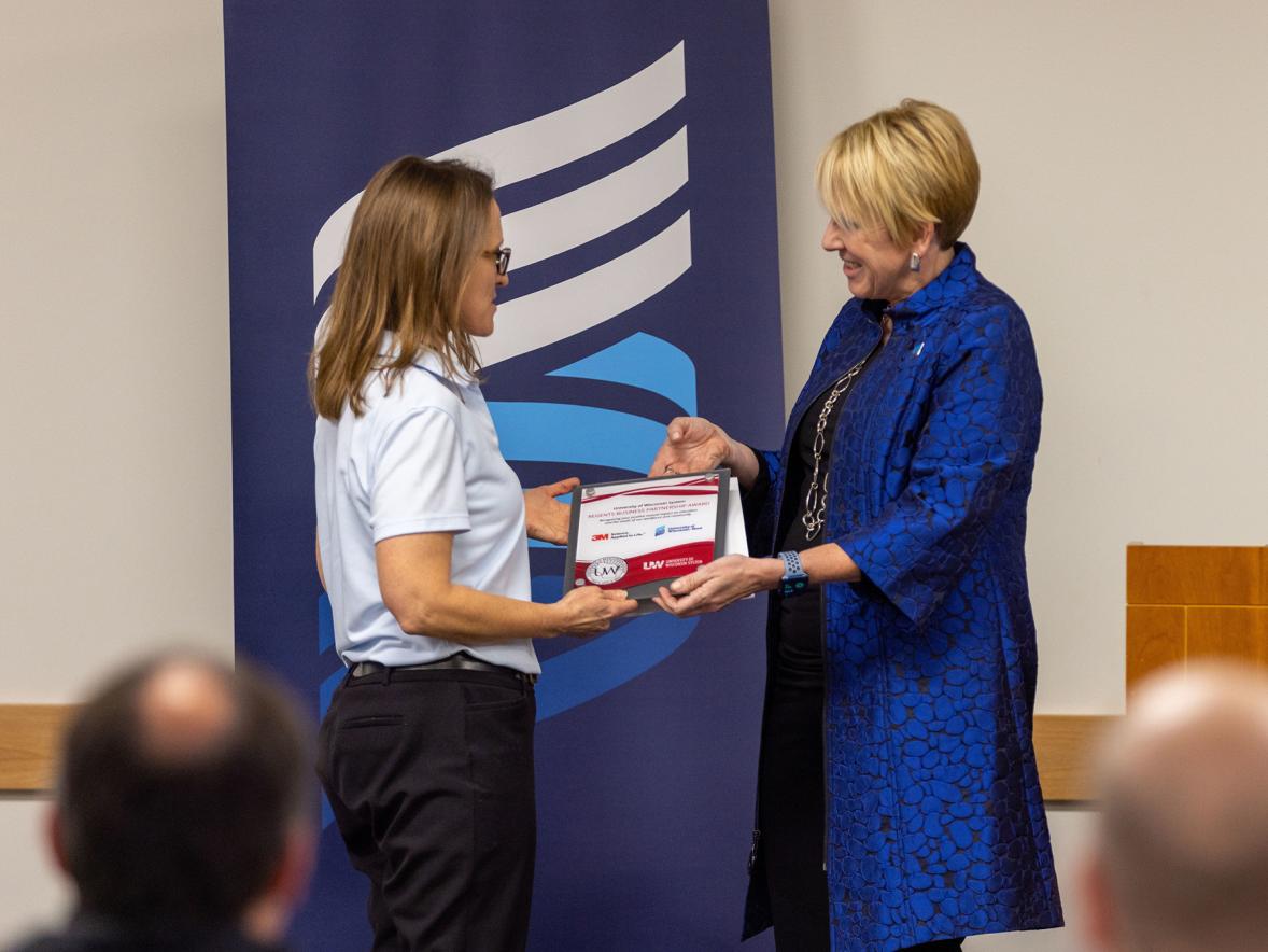 Chancellor Katherine Frank presents the award to 3M Site Director Janice Neitzel.