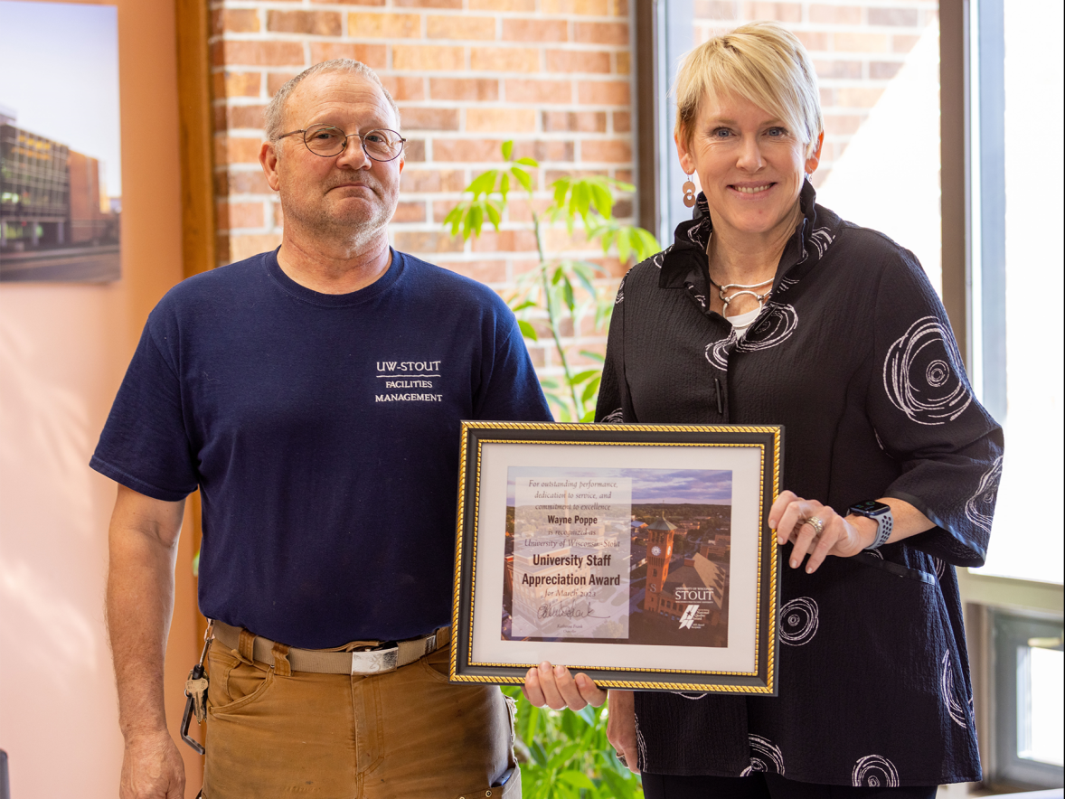 Wayne Poppe, left, receives the March University Staff Employee Appreciation award from Chancellor Katherine Frank.