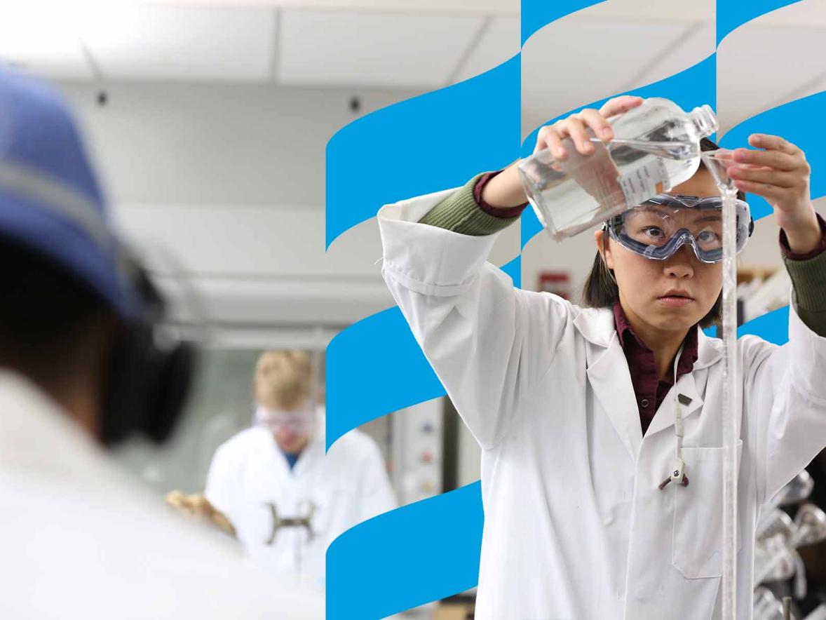 student pouring liquid during an experiment