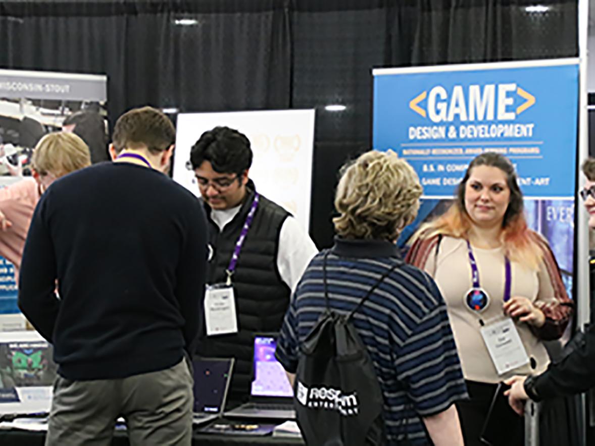Attendees at the M+DEV game conference in Madison visit the UW-Stout booth.