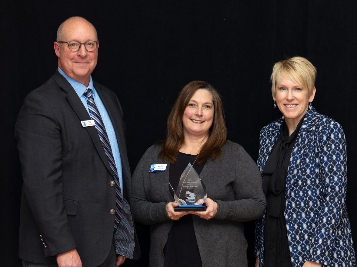 Beth Hein, center, executive director of Educational Pathways and Outreach, and Chancellor Katherine Frank accept UW-Stout’s Top Talent Initiative award from Momentum West’s Steve Jahn.