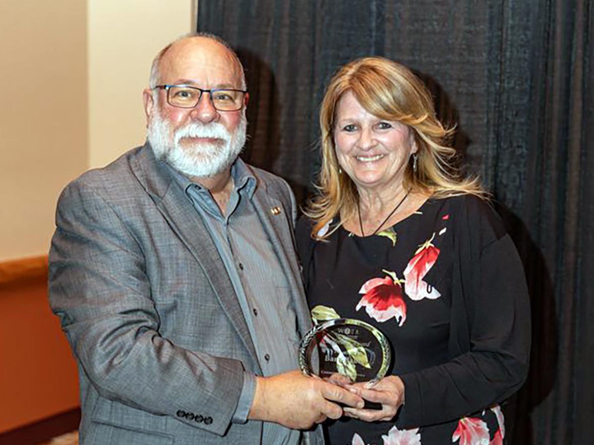 UW-Stout’s Barb Bauer receives the 2024 WTEA Leadership Award from Joe Ciontea, WTEA executive director.