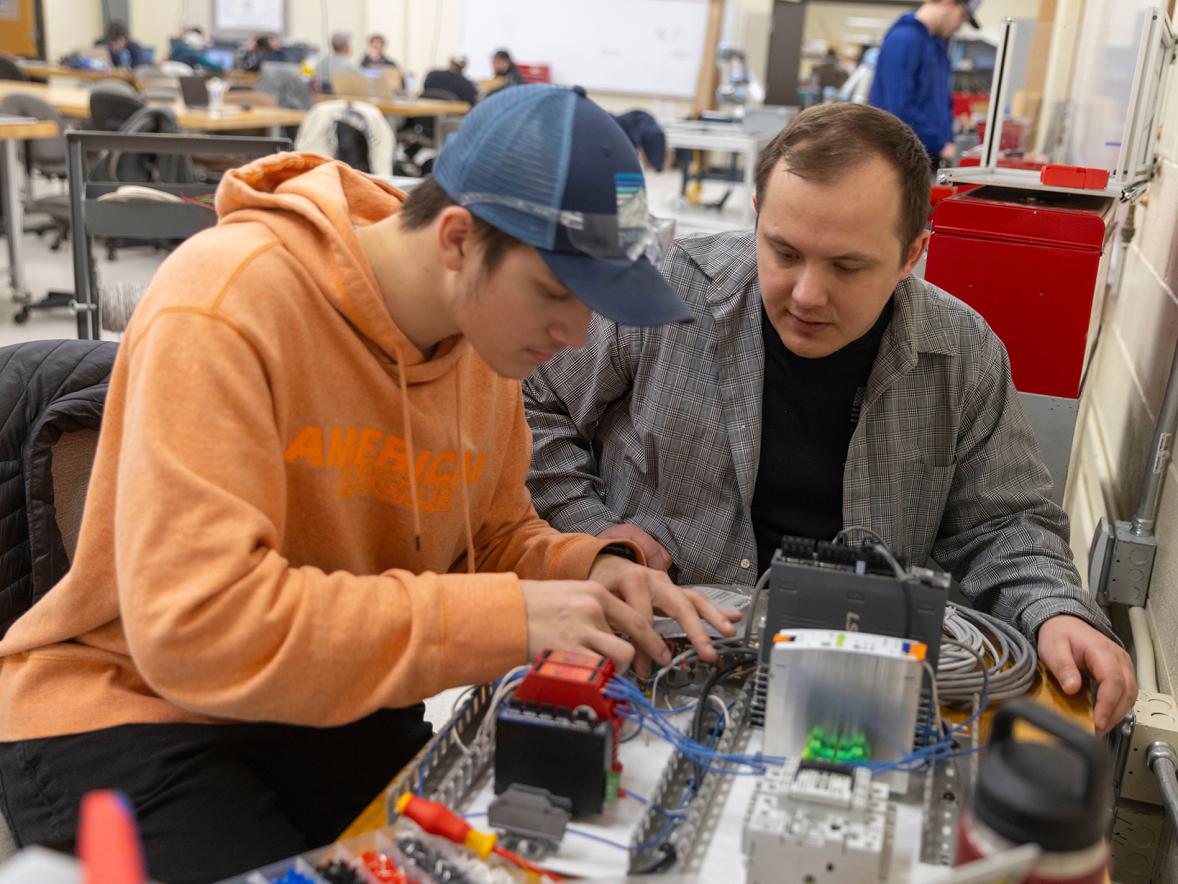 Tanner Hornung, mechanical engineering, and Aaron Philson, computer and electrical engineering, assemble the control board for their robotic go/nogo verification system project.