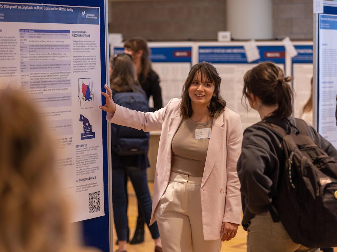 Student presenting poster on Research Day