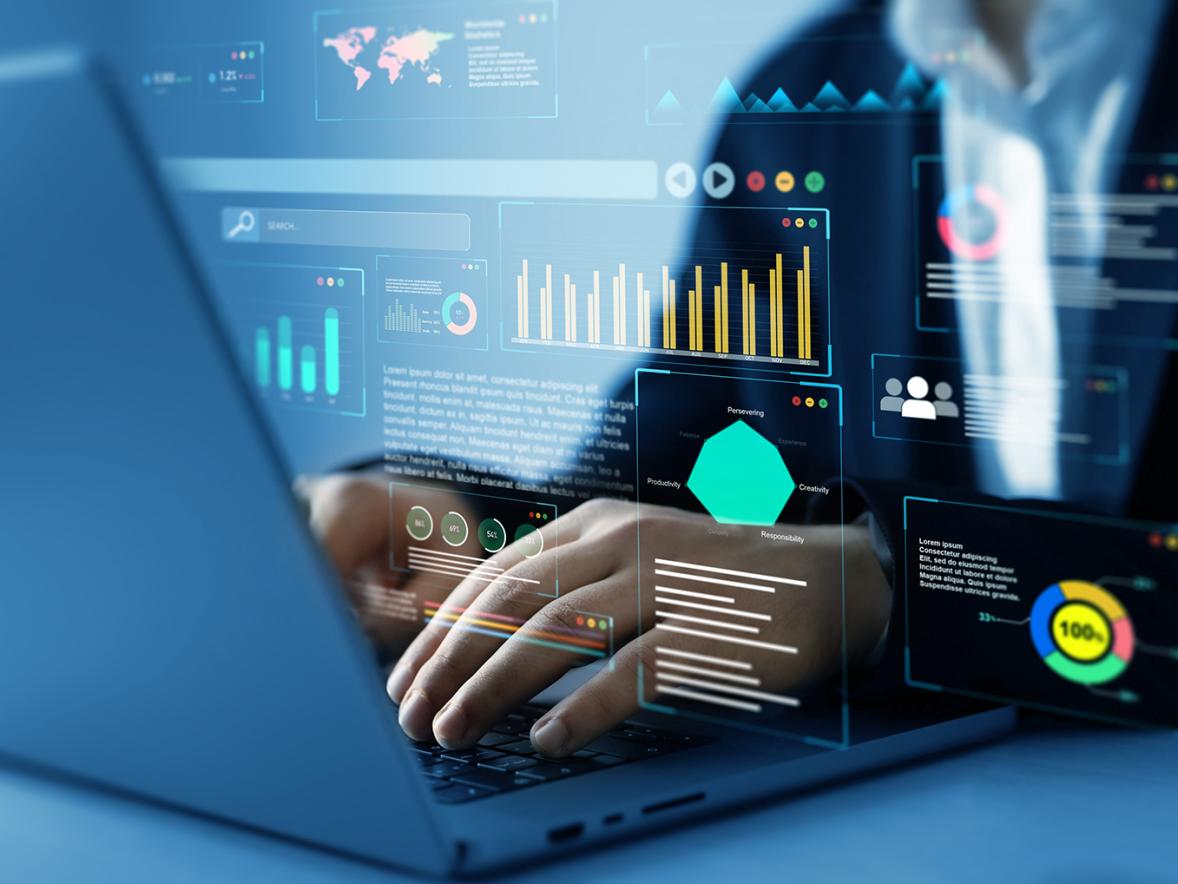 Close up of an employee's hands working on a computer with data visualization graphs and reports superimposed over the image.