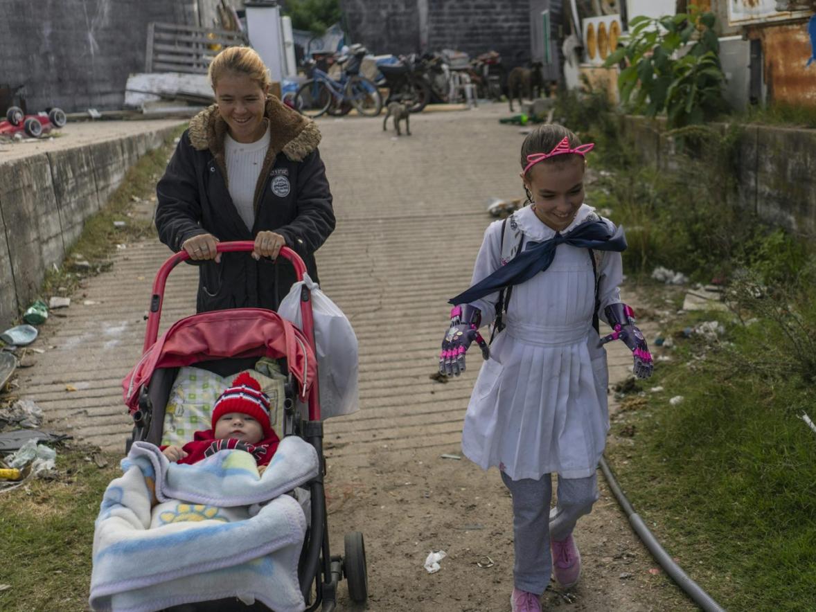 A girl, wearing her prosthetic hands, walks to school in Uruguay.