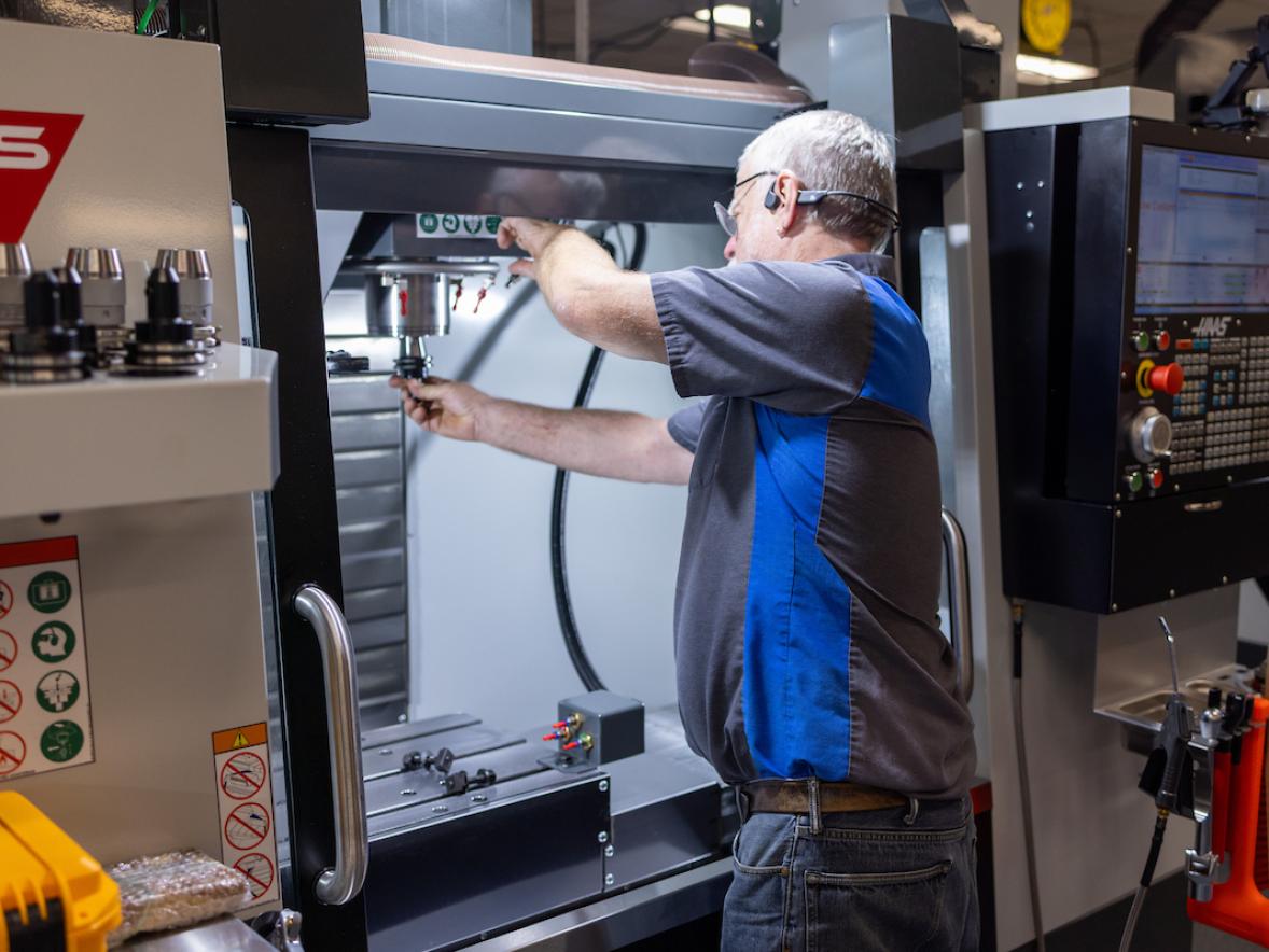 A man works on a large piece of lab equipment