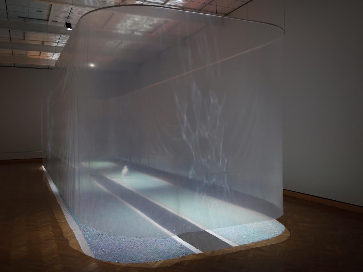 An art installation featuring light and plastic sheets mimicking a lagoon