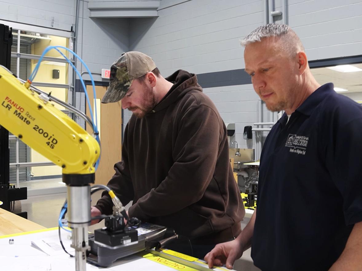Jason Solberg and a student in an automation lab