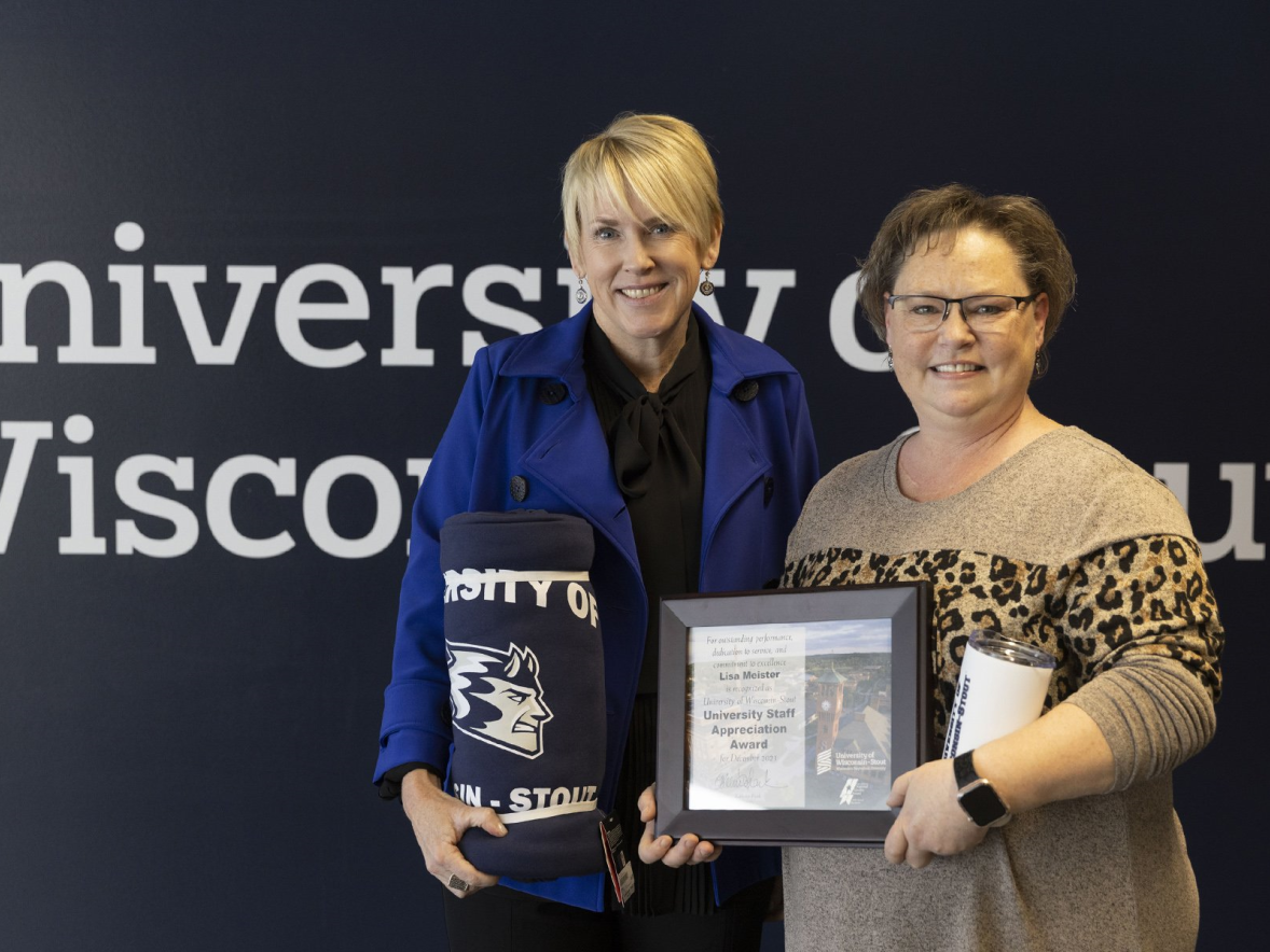 Two women holding award