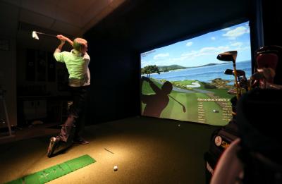 Golf Enterprise Management student on virtual practice turf