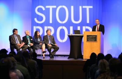 Pictured on stage at the podium is Phil Lyons, Vice Chancellor for Administrative and Student Life Services. Seated from left is Charles Bomar, Dean of the STEM College; Patrick Guilfoile, Provost and Vice Chancellor for Academic and Student Affairs; Meridith Drzakowski, Assistant Chancellor; and Bob Meyer, Chancellor.