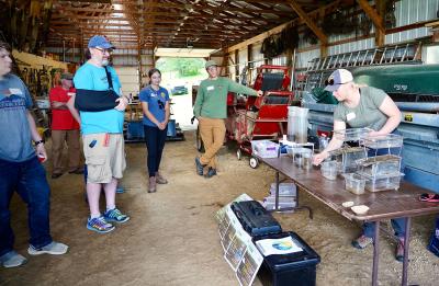 The LAKES team watches a soil health demo by Holly Geurts, National Resources Conservation Service staff.