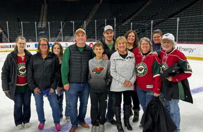 Group of alumni on the ice after a Minnesota Wild Game. 