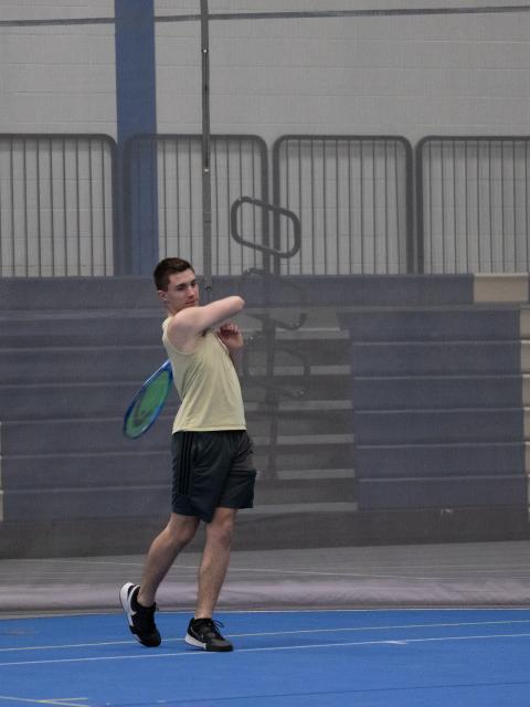Individual returning tennis ball